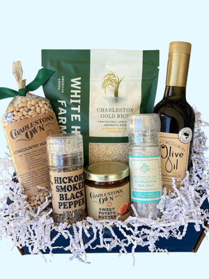 Charleston Gourmet gift box filled with White House Farms Charleston Gold Rice,
Charleston's Own Hoppin' John Black-Eyed Peas, Lowcountry Olive Oil, Bulls Bay Sea Salt, Hickory Smoked Black Pepper, and Charleston's Own Sweet Potato Butter packed in a branded navy blue gift box.