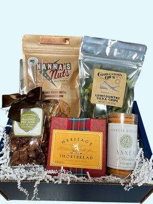 Medium Holiday Snack Box with Nanna's Pecan Brittle, Charleston's Own Okra Chips, Charleston Favorites Pralined Pecans, Heritage Shortbread, and Anne's of Charleston Cheese Biscuits packed in a branded box - Essentially Charleston